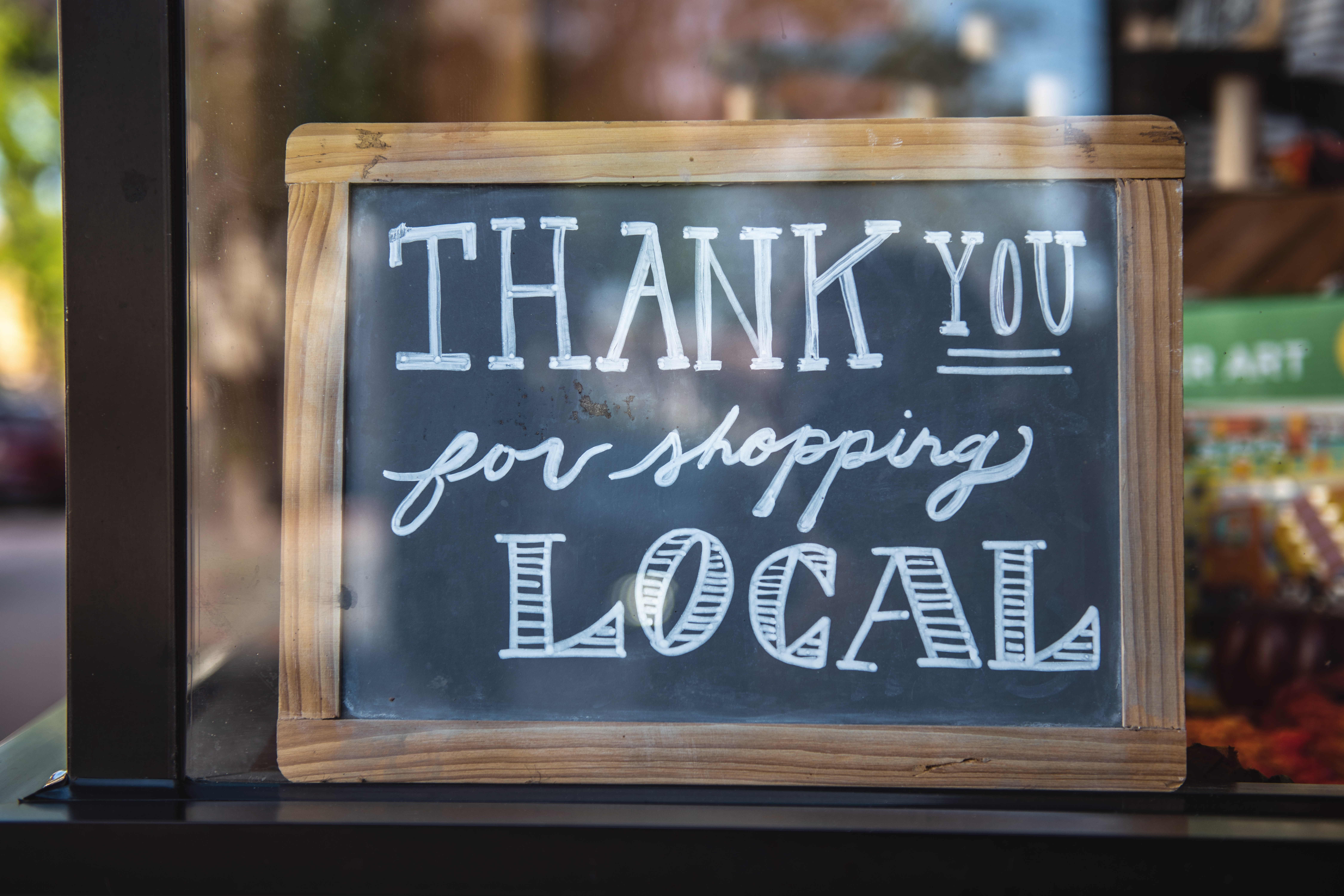 chalk board sign saying thank you for shopping loxal